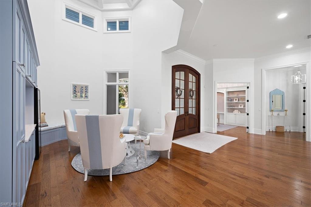 610 Springline Drive Naples, FL 34102 - Photo 23 of 49 a view of a dining room with furniture and wooden floor