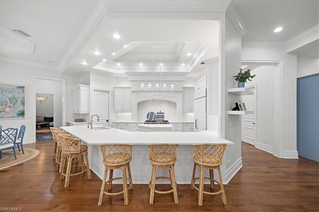 610 Springline Drive Naples, FL 34102 - Photo 26 of 49 a view of a dining room with furniture and wooden floor
