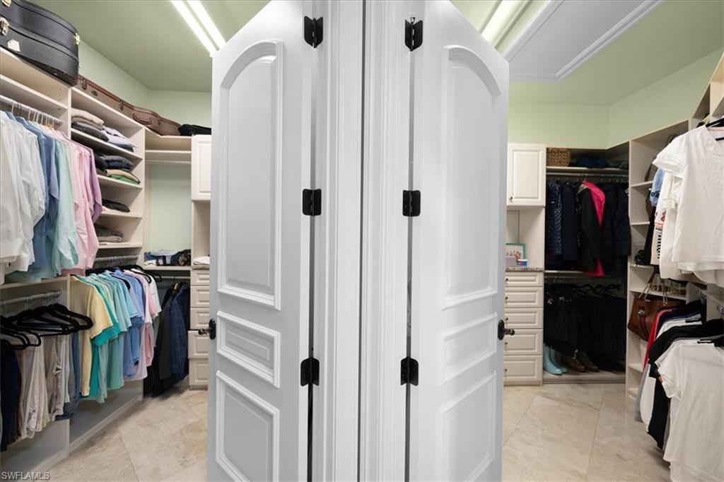 610 Springline Drive Naples, FL 34102 - Photo 33 of 49 a view of walk in closet with clothes