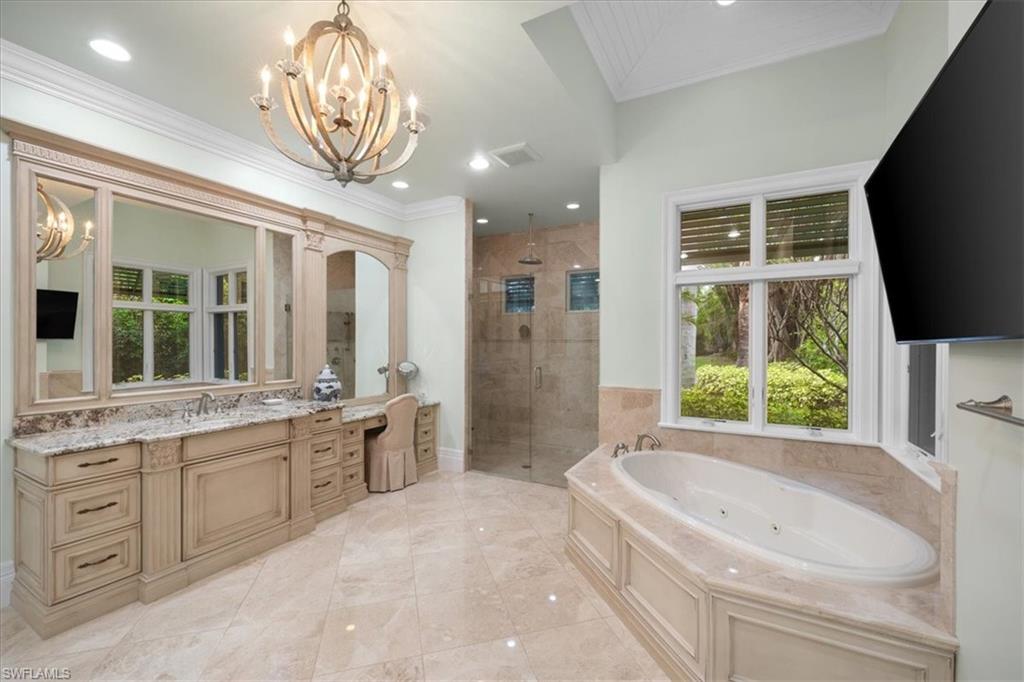 610 Springline Drive Naples, FL 34102 - Photo 36 of 49 a large bathroom with a large tub and sink