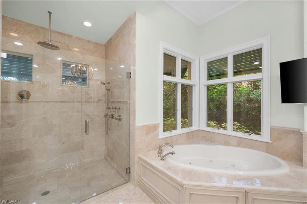 610 Springline Drive Naples, FL 34102 - Photo 38 of 49 a bathroom with a bathtub and a shower