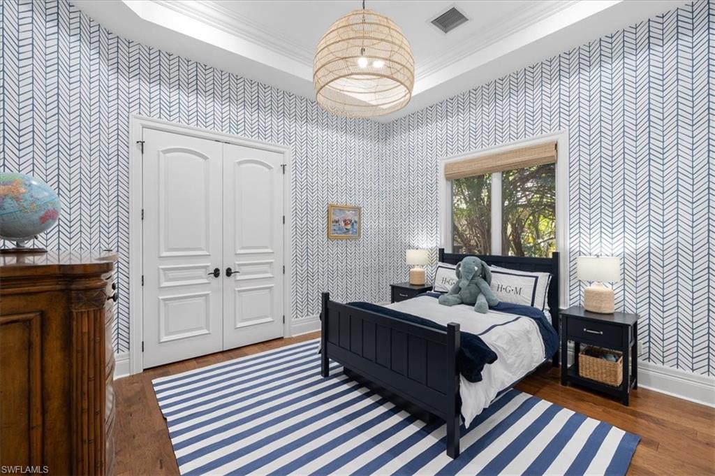 610 Springline Drive Naples, FL 34102 - Photo 39 of 49 a bedroom with bed and wooden floor