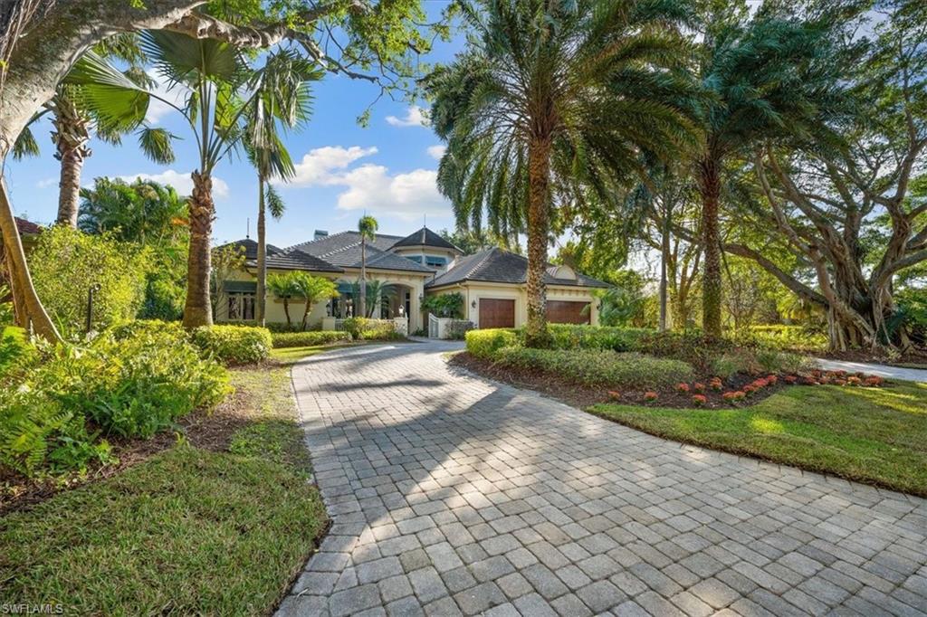 610 Springline Drive Naples, FL 34102 - Photo 4 of 49 a view of a yard with plants and trees