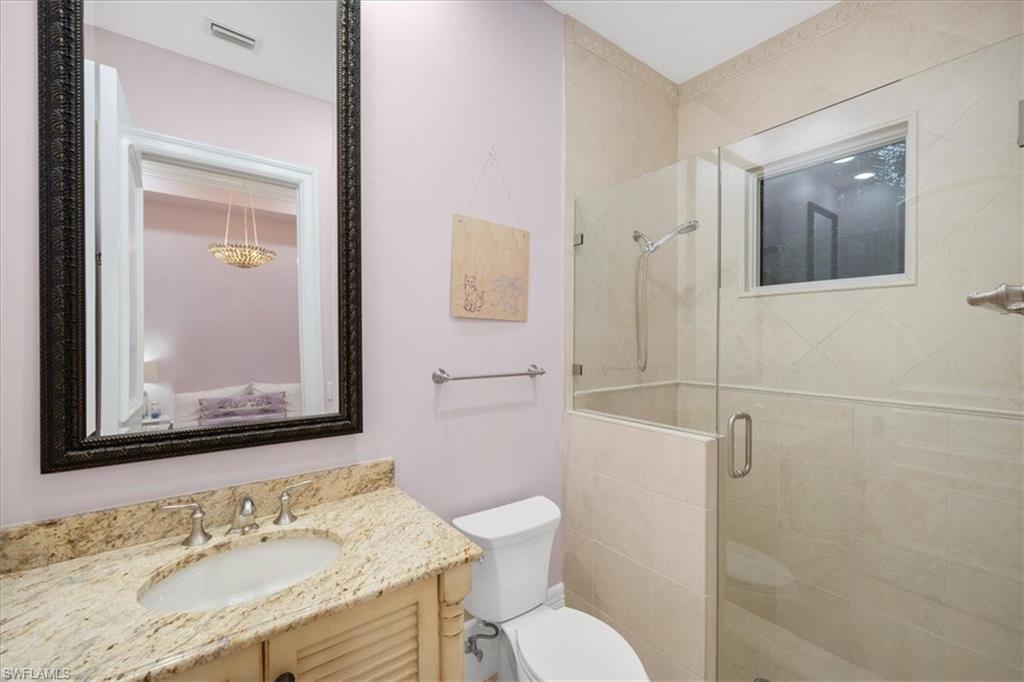 610 Springline Drive Naples, FL 34102 - Photo 43 of 49 a bathroom with a granite countertop sink toilet and shower