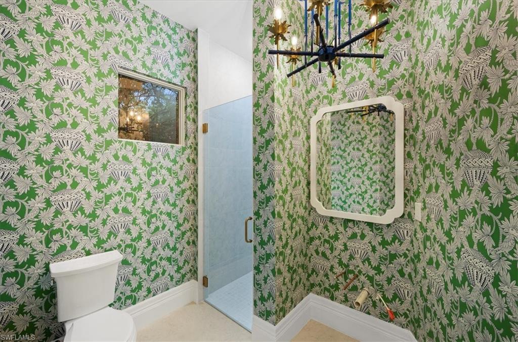 610 Springline Drive Naples, FL 34102 - Photo 45 of 49 a bathroom with a toilet and a shower curtain