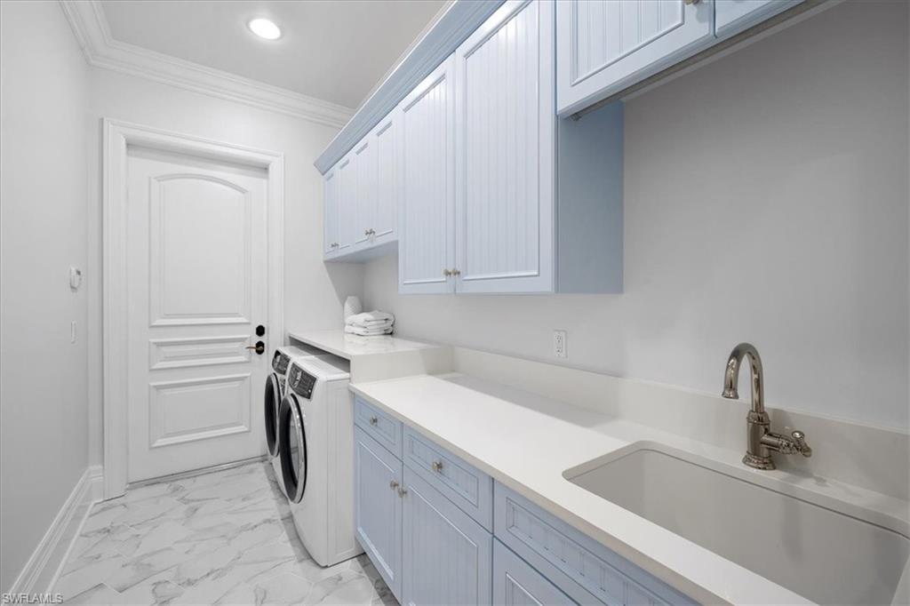 610 Springline Drive Naples, FL 34102 - Photo 46 of 49 a view of a kitchen with sink washer and dryer