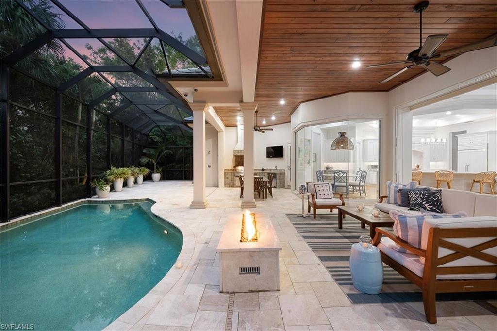 610 Springline Drive Naples, FL 34102 - Photo 6 of 49 Spacious and expansive lanai with fire, kitchen, grill and lots of gathering spaces