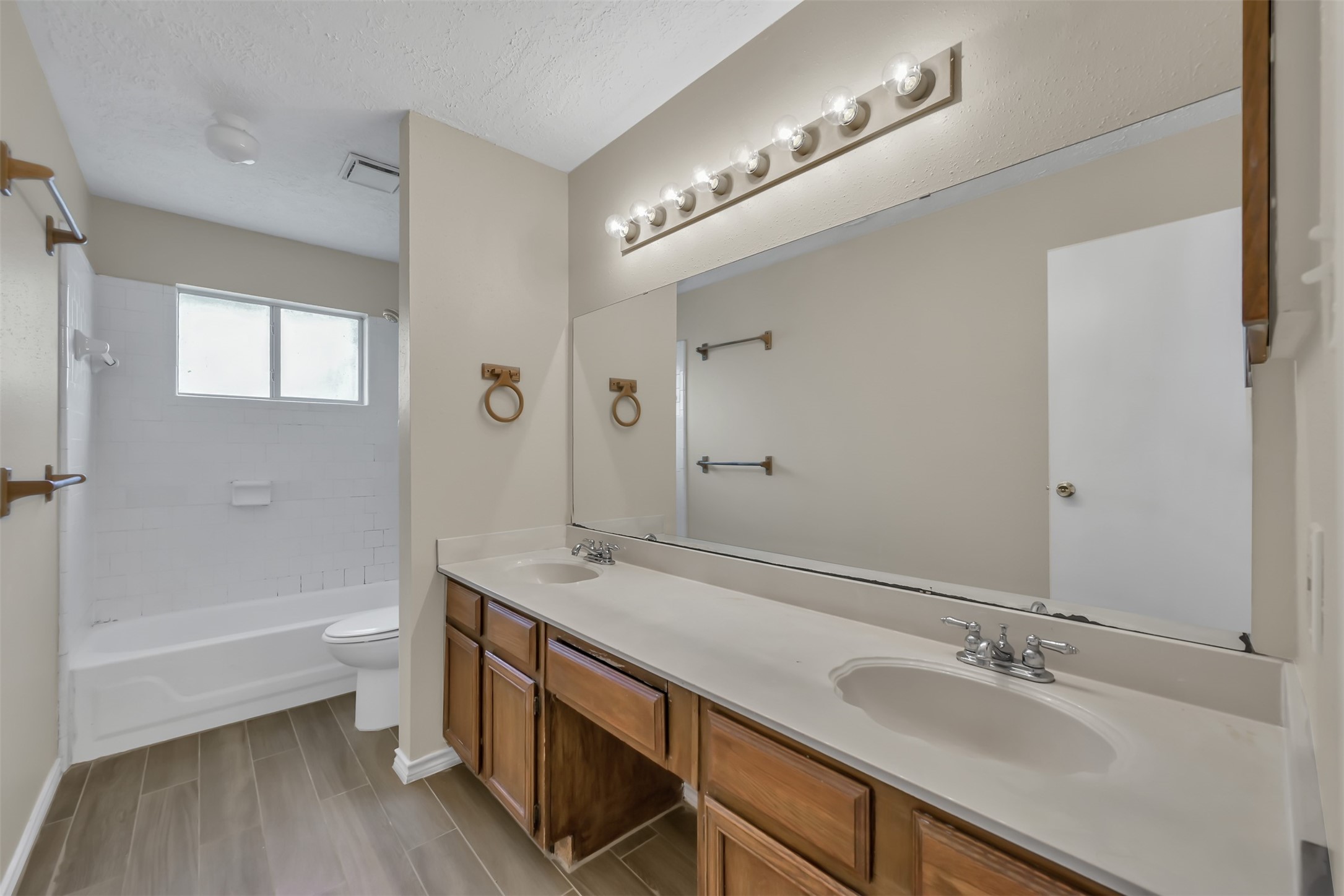22112 Peachglen Lane Spring, TX 77373 - Photo 12 of 17 a bathroom with a double vanity sink a toilet and shower