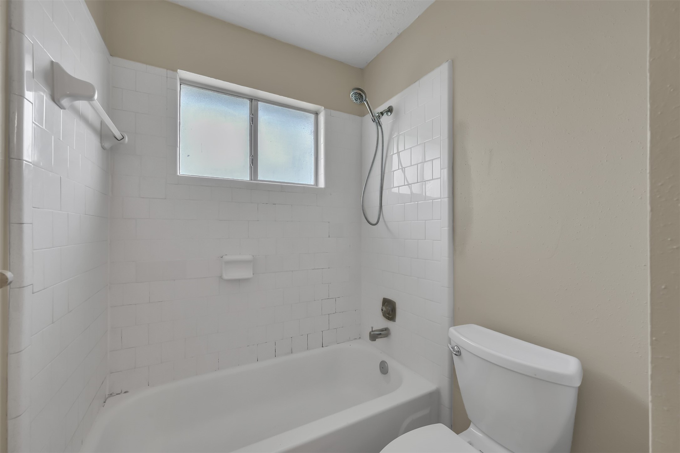 22112 Peachglen Lane Spring, TX 77373 - Photo 13 of 17 a bathroom with a toilet and a bathtub