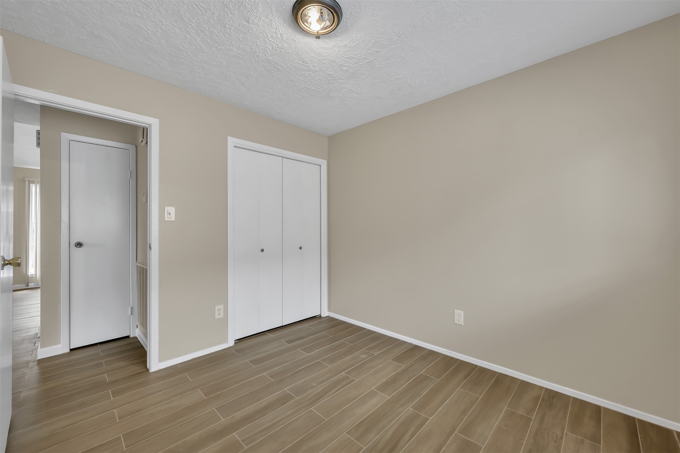 22112 Peachglen Lane Spring, TX 77373 - Photo 16 of 17 a view of an empty room with wooden floor and closet