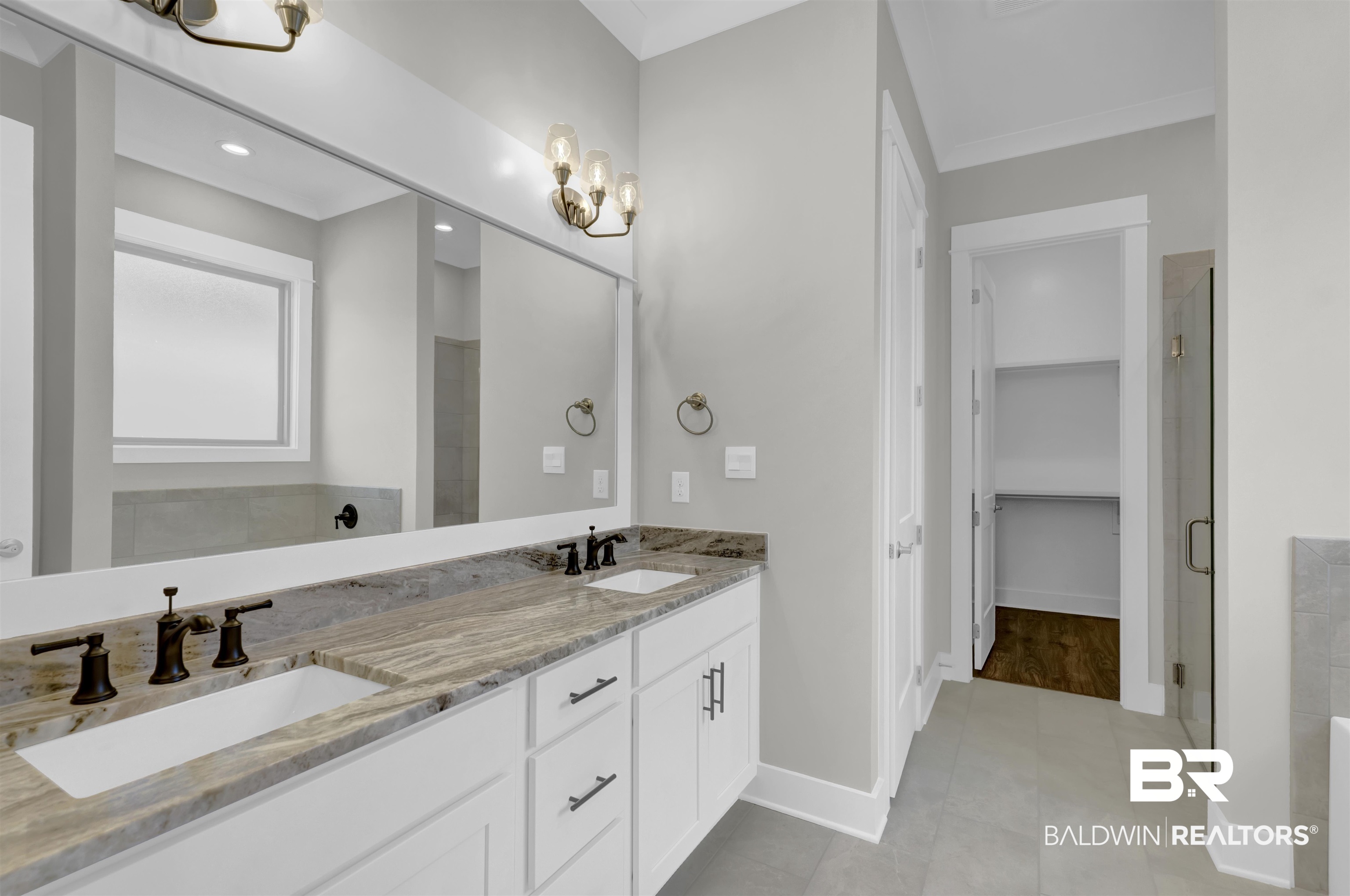 571 Morning Mist Way Fairhope, AL 36532 - Photo 22 of 47 Full bathroom featuring double vanity, a walk in closet, a stall shower, a chandelier, and light tile patterned flooring