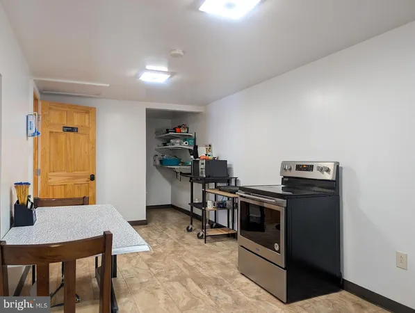 a view of an empty room with wooden floor and closet