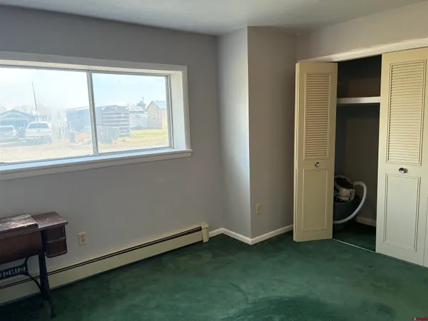 an empty room with a window and a gate