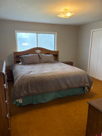 a bedroom with a bed and window