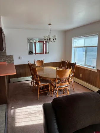 a view of a dining room with furniture and a window