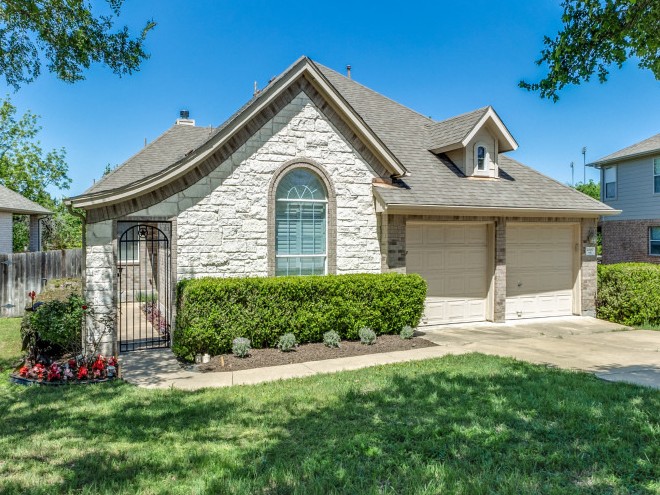2000 Westfalian Trail, Unit 6 Austin, TX 78732 - Photo 1 of 22 a front view of a house with a garden