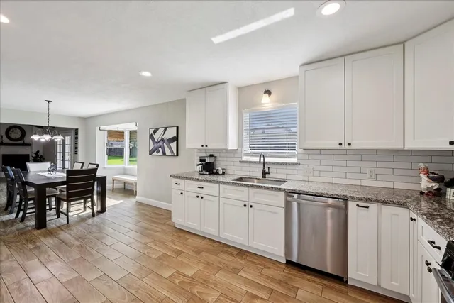 a kitchen with sink cabinets and dining table chair