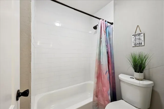 a bathroom with a toilet a sink and a bathtub