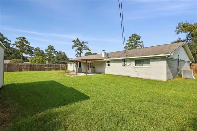 a view of an house with backyard space and garden