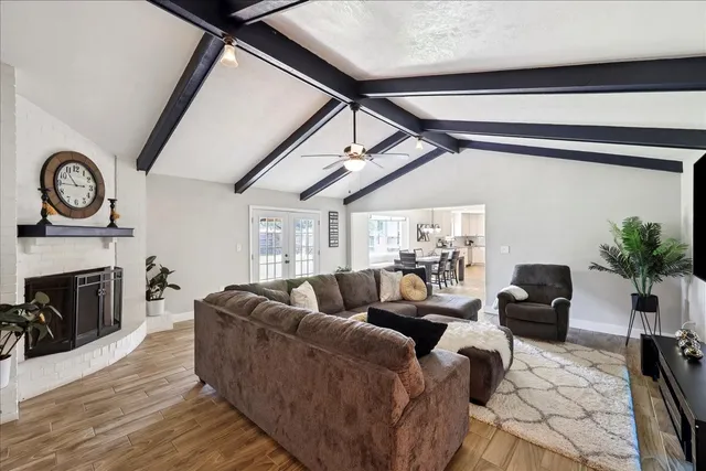a living room with furniture a fireplace and a potted plant
