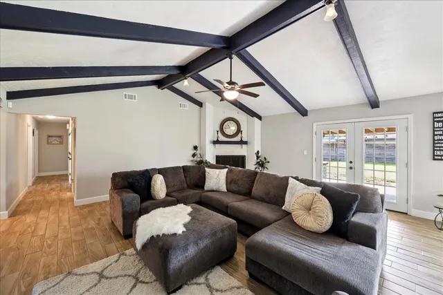 a living room with furniture and wooden floor