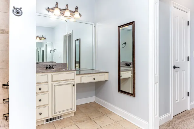 a bathroom with a sink vanity and mirror