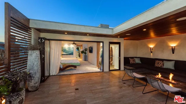 a bedroom with a bed lamp and a potted plant