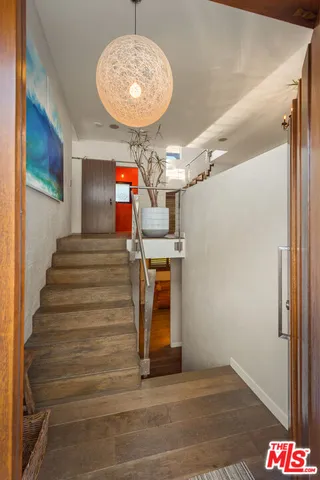 a large bedroom with a bed and a large window