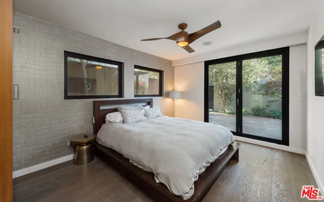 a large bedroom with a bed and wooden floor