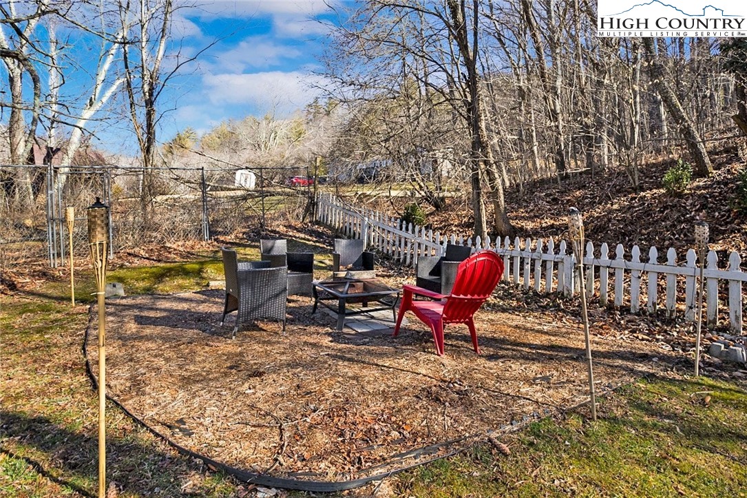 1670 Highway 194 Boone, NC 28607 - Photo 22 of 30 a view of a backyard with table and chairs with wooden fence