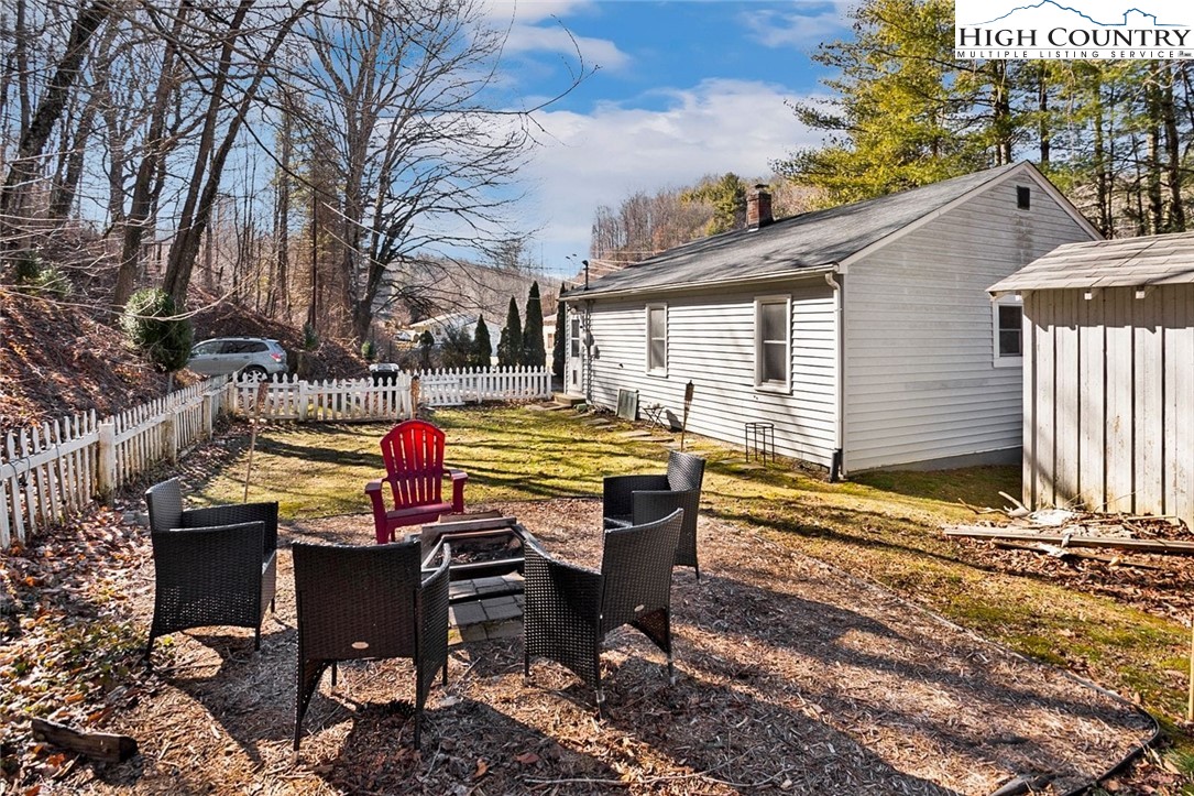 1670 Highway 194 Boone, NC 28607 - Photo 23 of 30 a backyard of a house with barbeque oven table and chairs