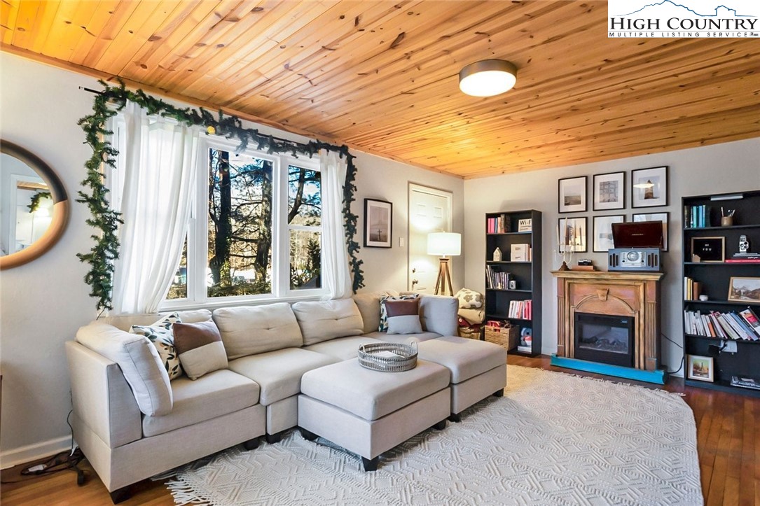1670 Highway 194 Boone, NC 28607 - Photo 9 of 30 a living room with furniture a fireplace and a large window