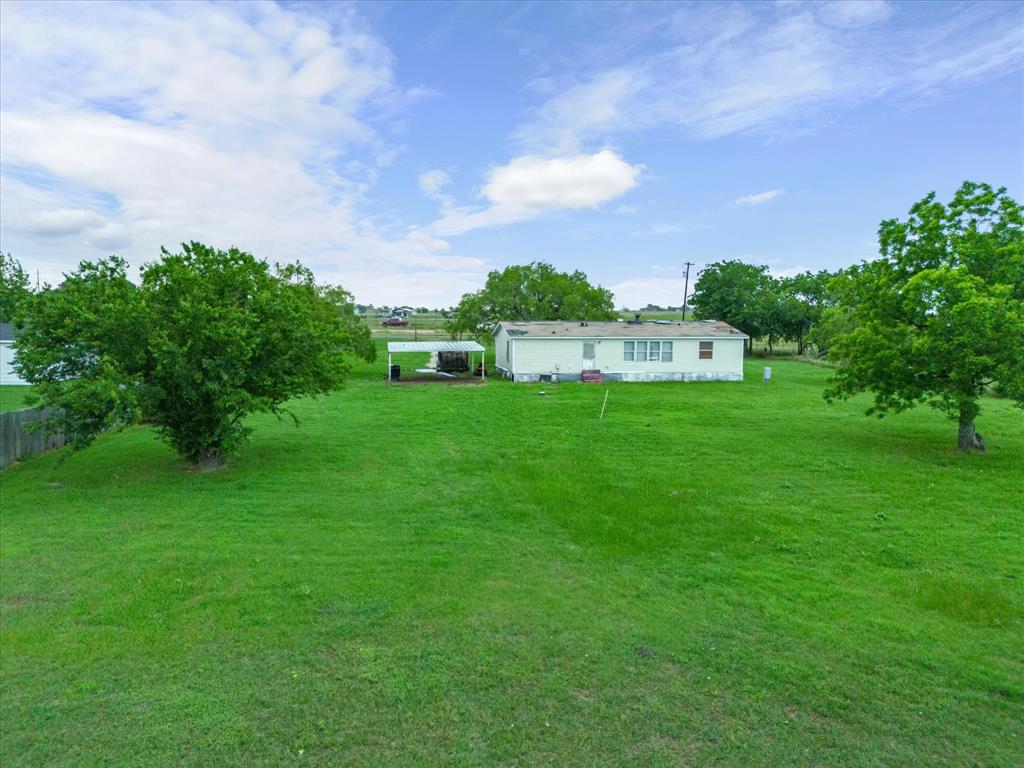 7311 South Interstate 45 Service Road Alma, TX 75119 - Photo 6 of 7 a backyard of a house with lots of green space