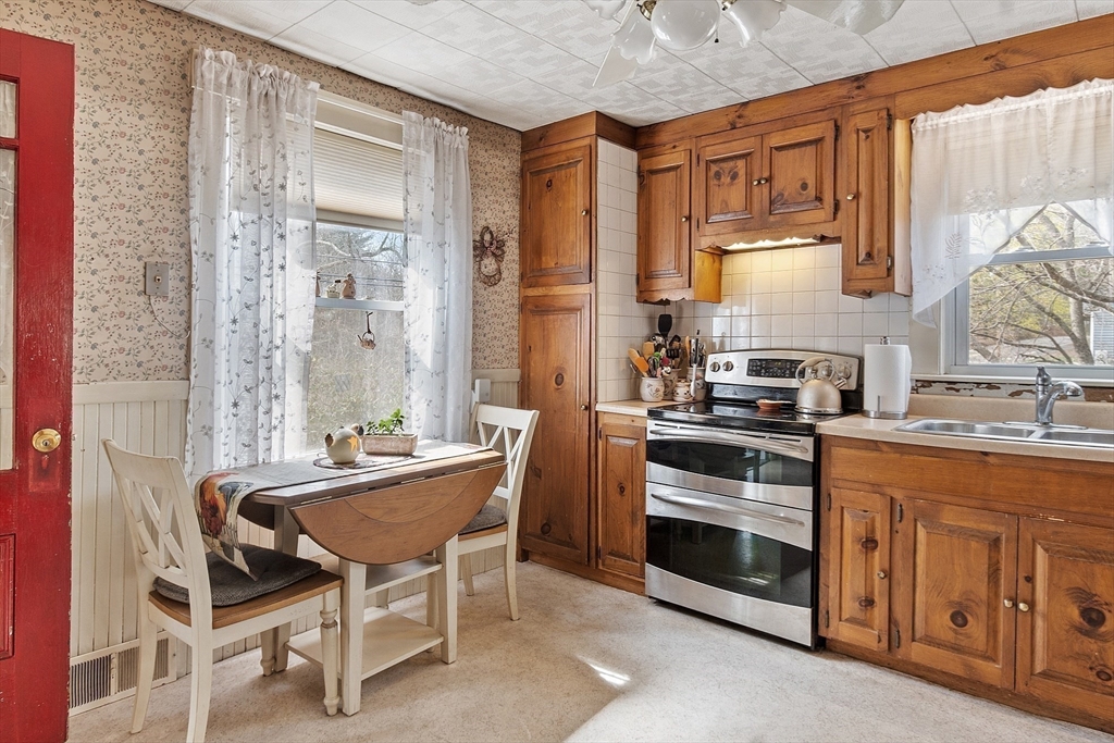 346 Townsend Road Groton, MA 01450 - Photo 16 of 43 a kitchen with a stove a sink and a refrigerator