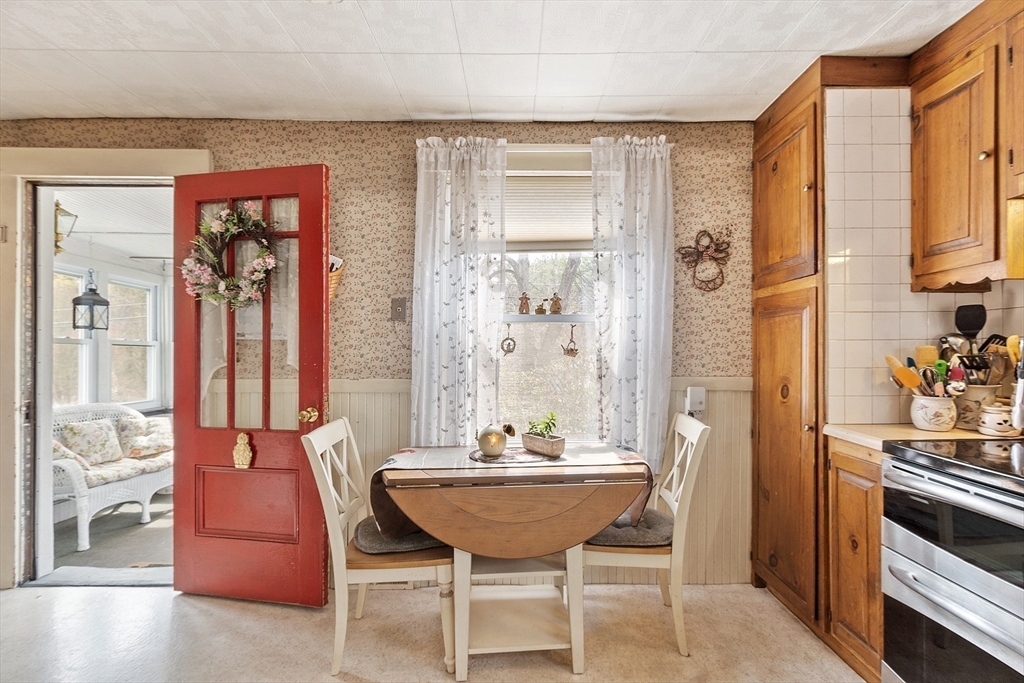 346 Townsend Road Groton, MA 01450 - Photo 17 of 43 a view of a dining room with furniture and a chandelier