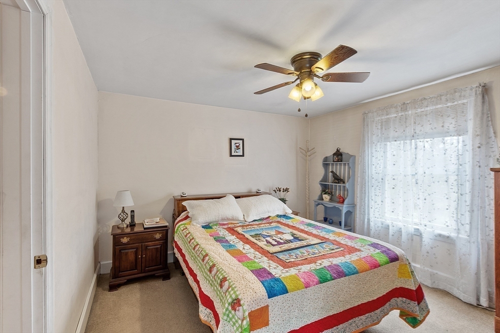 346 Townsend Road Groton, MA 01450 - Photo 32 of 43 a bedroom with a bed and a chandelier