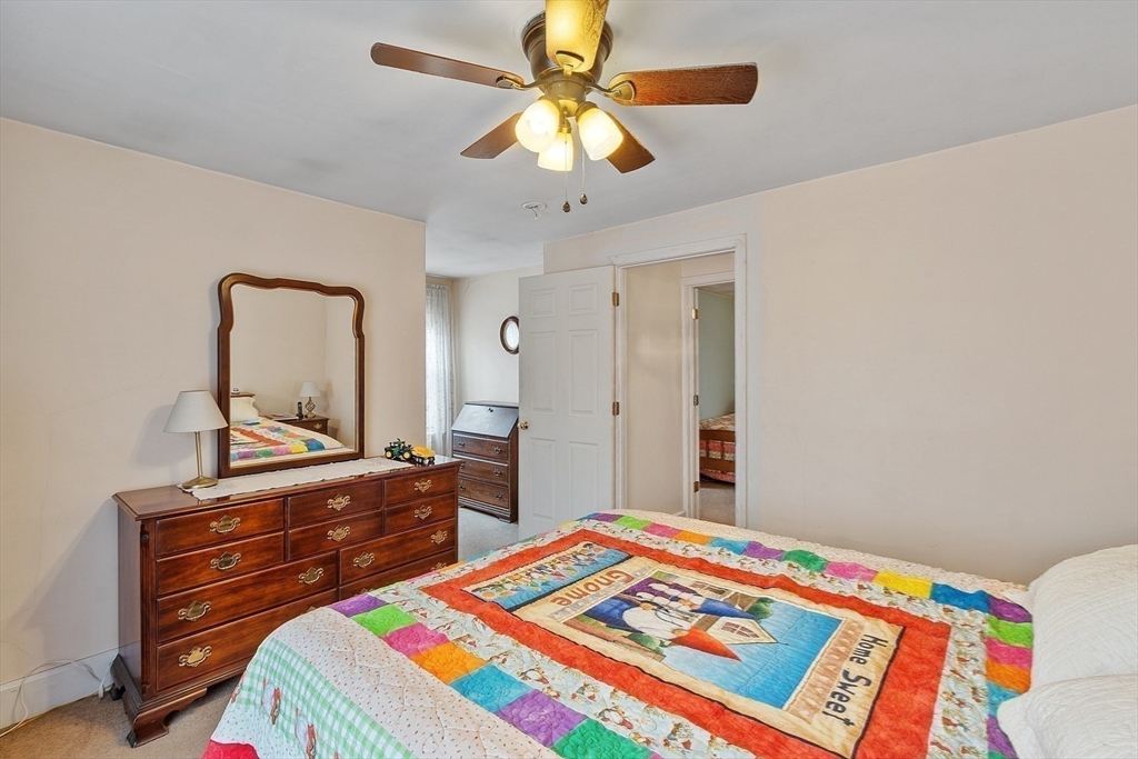 346 Townsend Road Groton, MA 01450 - Photo 33 of 43 a bedroom with a bed and a chandelier