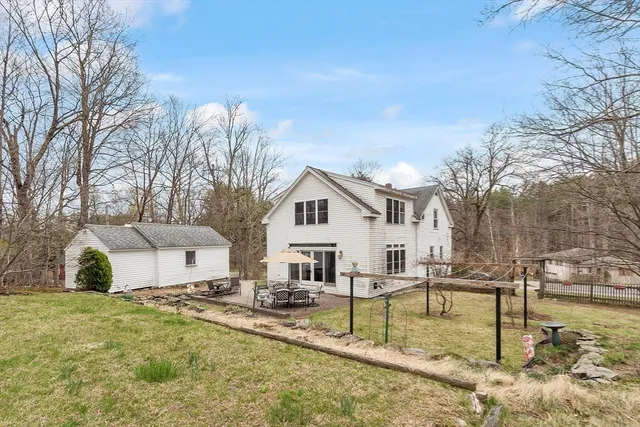 a patio with a table and chairs under an umbrella