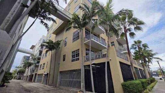 444 Northwest 1st Avenue, Unit 502 Fort Lauderdale, FL 33301 - Photo 2 of 10 a view of small house with a palm tree