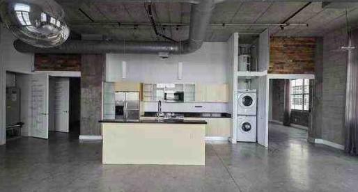 444 Northwest 1st Avenue, Unit 502 Fort Lauderdale, FL 33301 - Photo 4 of 10 a kitchen with stainless steel appliances granite countertop a sink and a refrigerator
