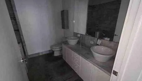 a bathroom with a granite countertop sink toilet and a mirror