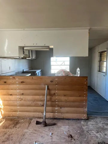 a view of room with cabinets and wooden floor