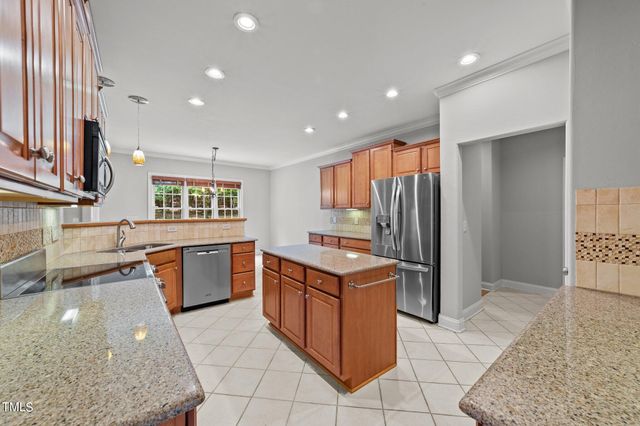 a kitchen with stainless steel appliances granite countertop a sink and a stove