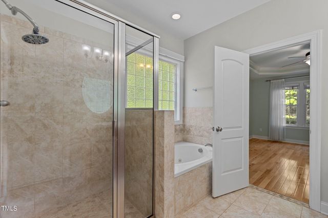 a bathroom with a bathtub shower and toilet