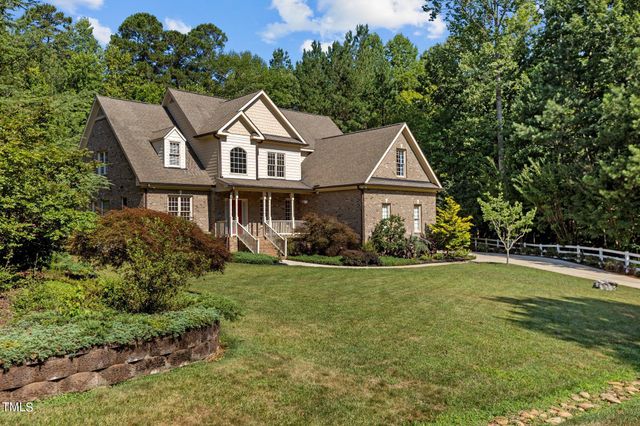a view of a house with a yard and plants