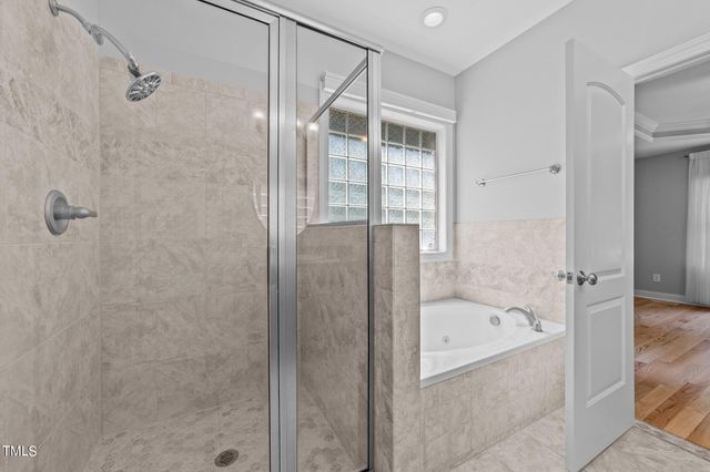 a bathroom with a bathtub and shower