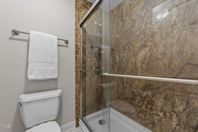 a bathroom with a shower and toilet