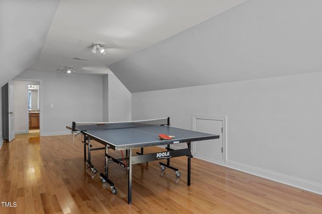 a view of a room with furniture and wooden floor