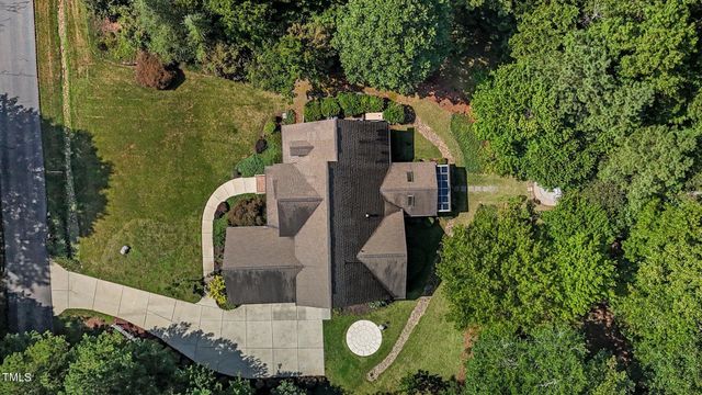 an aerial view of a house with a yard and trees