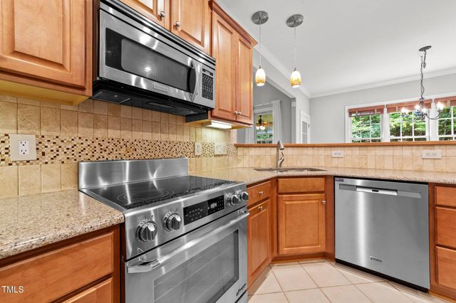 a kitchen with granite countertop cabinets stainless steel appliances and a counter space